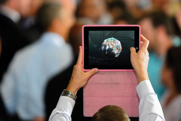 Man filming video using Apple iPad