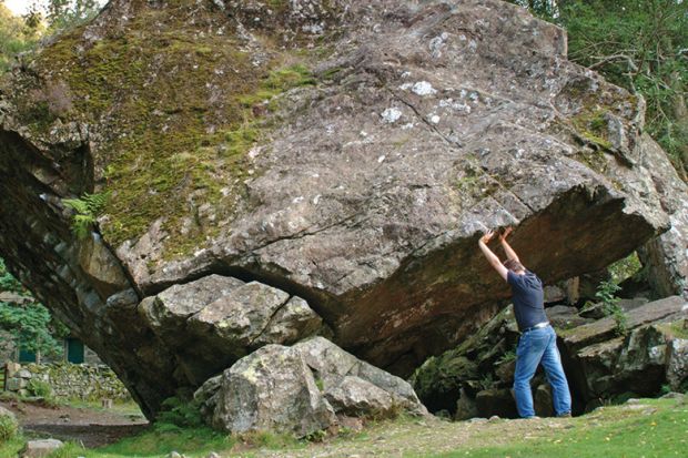 Man holding up rock