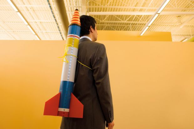 Man in suit with rocket strapped to back