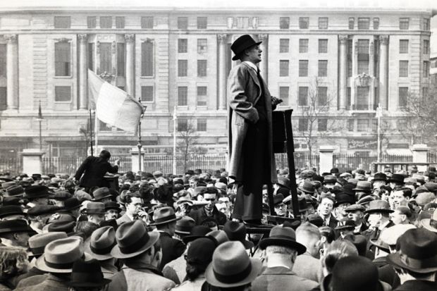 Man speaking to large crowd of people