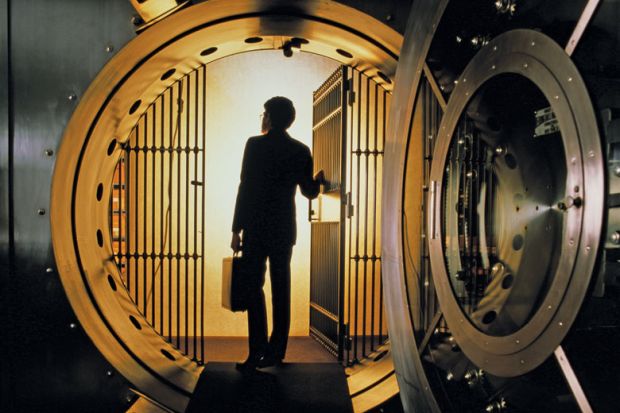 Man walking into bank vault