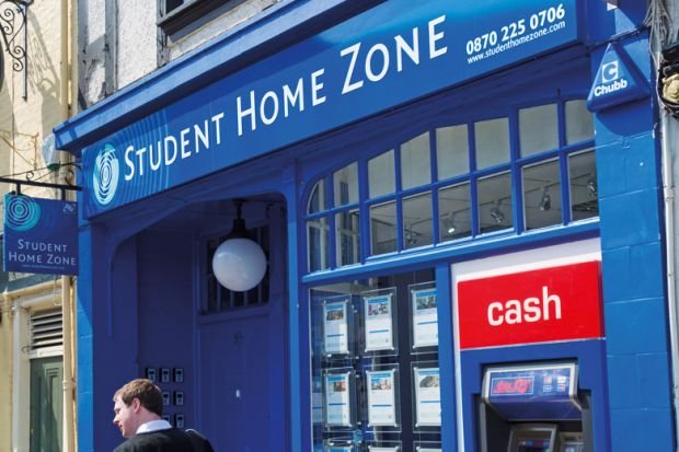 Man walking past Student Home Zone office