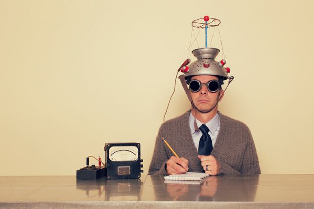 Man with colander on his head connected to electrodes