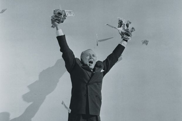 Man celebrating with hands full of cash