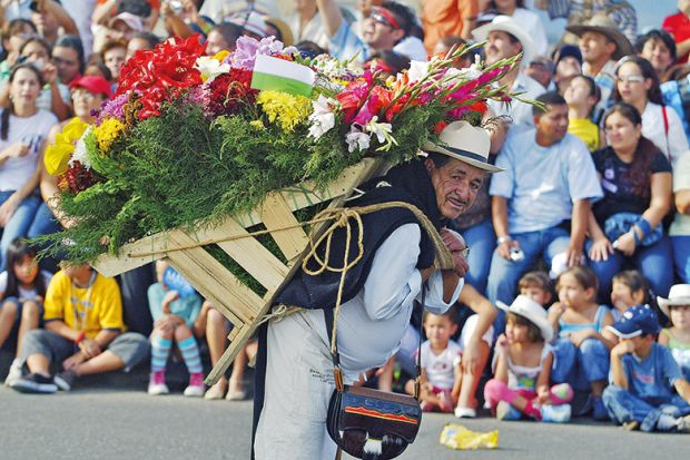 A man with a lot of flowers on his back