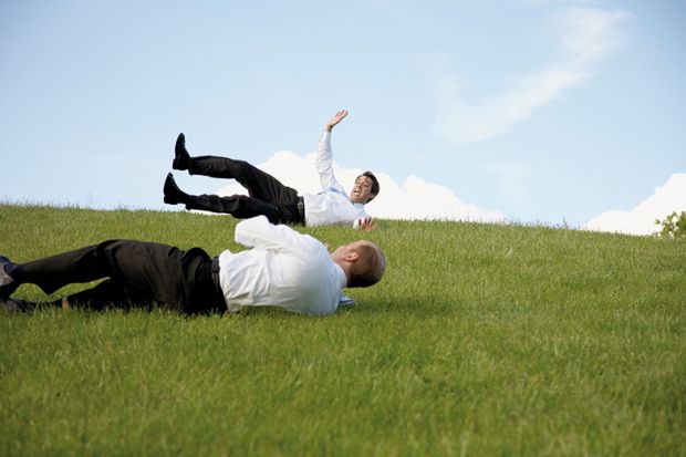 Men rolling down a hill