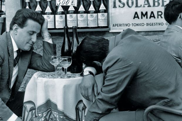 Men slumped at table