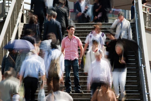 Man standing out from crowd.