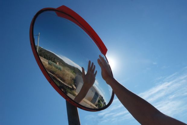 Hand reflecting in a mirror