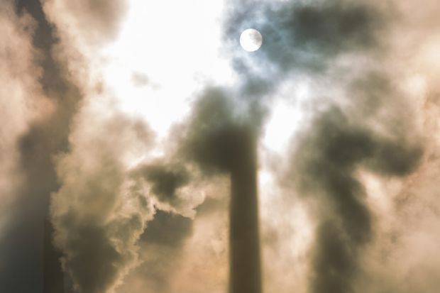 Moonlit sky behind clouds of smoke