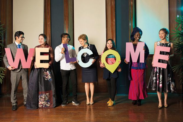 Nicola Sturgeon with WELCOME sign