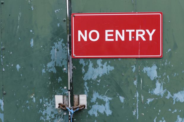 A no entry sign on a locked door illustrating visa application issues, UK Home Office, academic spouse visa