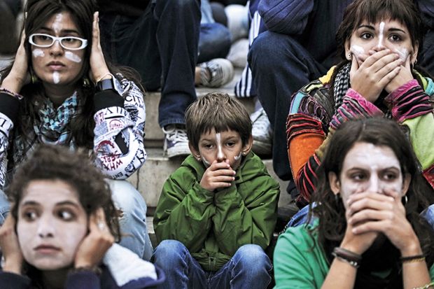 At an Occupy protest, people cover their mouths and ears