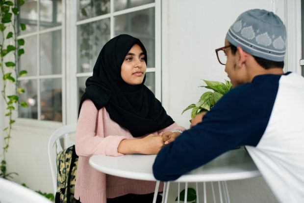 A Pakistani man and woman talking