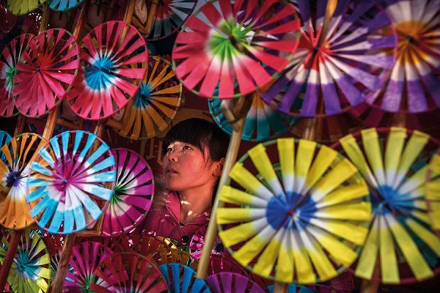 Girl surrounded by umbrellas