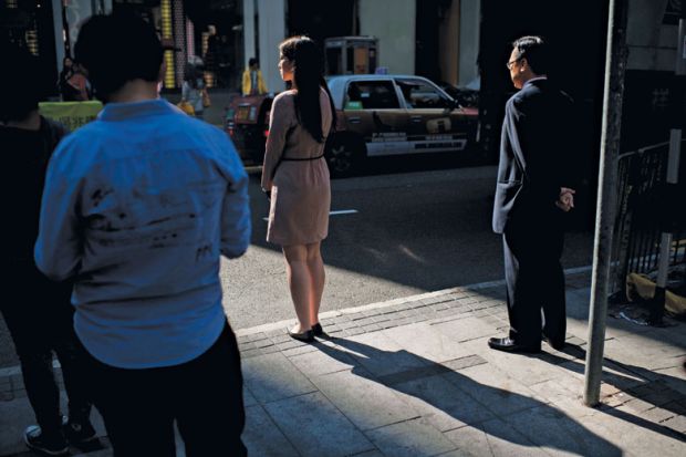 Pedestrians waiting to cross the road, Hong Kong