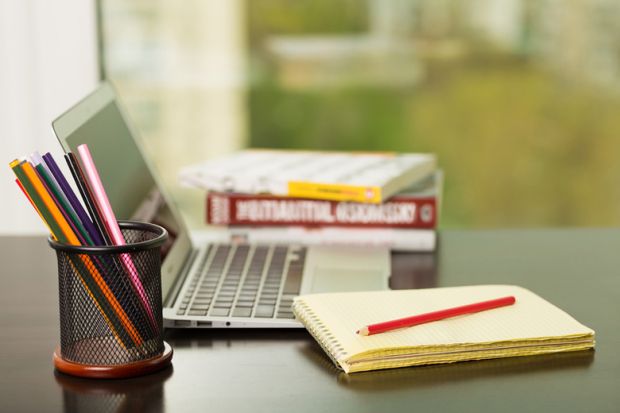 Laptop, books and pencils