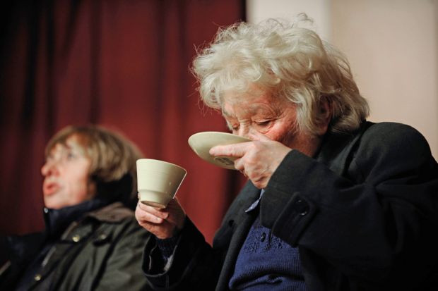 Woman drinking tea from saucer