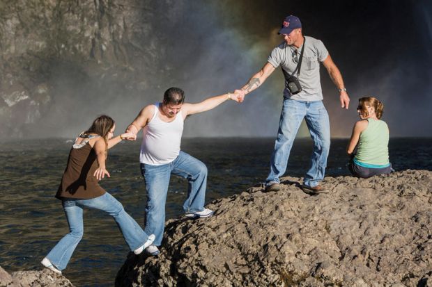 People climbing rocks, Snoqualmie Falls, Washington