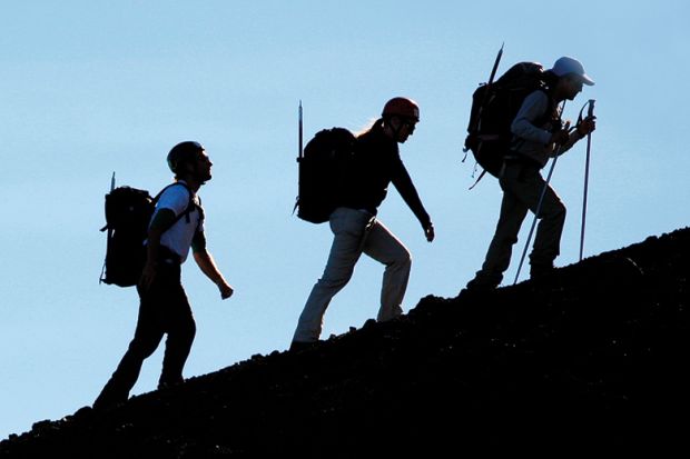 People hiking up mountain