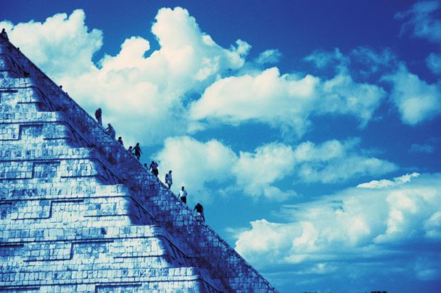 People climbing Aztec-style temple