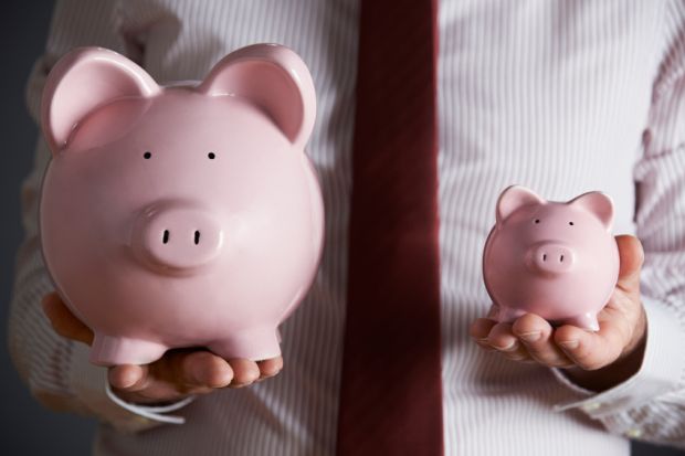 Man holding two piggy banks