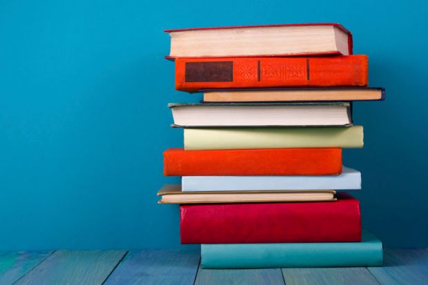 Pile of books against blue background