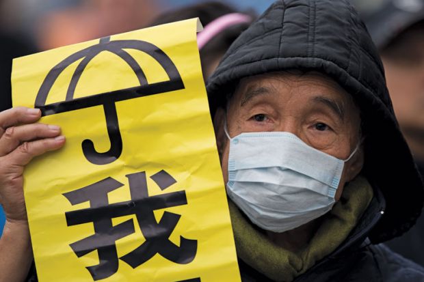 Protestor holding banner, Admiralty District, Hong Kong