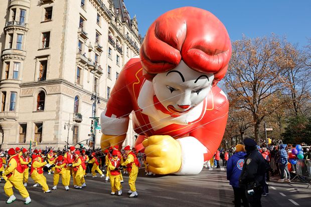 Ronald McDonald balloon hits the ground as it is pulled along Central Park West during the annual Macy's Thanksgiving Day Parade in New York City,