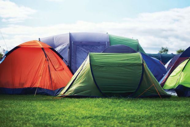 Row of tents in field