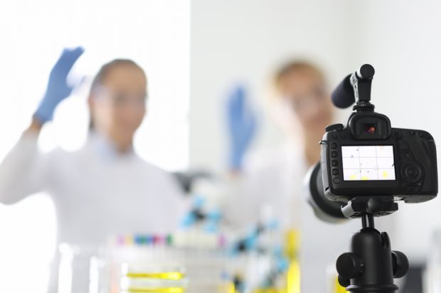 A camera films a scientist, symbolising science communication