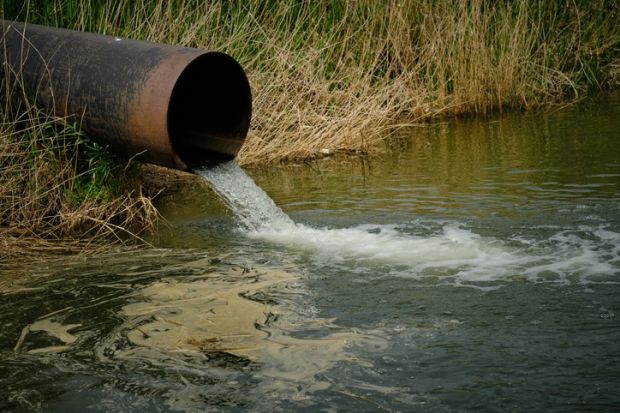 A pipe drains sewage into a river