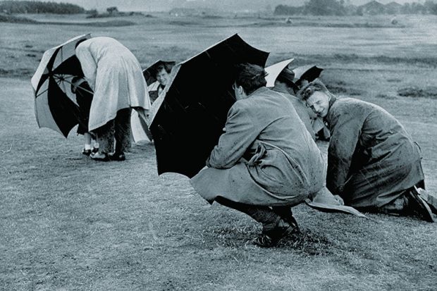 Sheltering under umbrellas