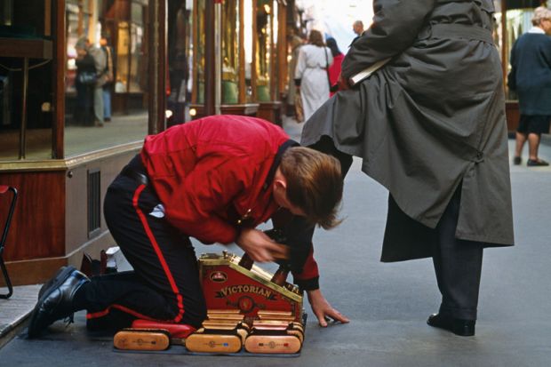 Shoeshine boy polishing man's shoes