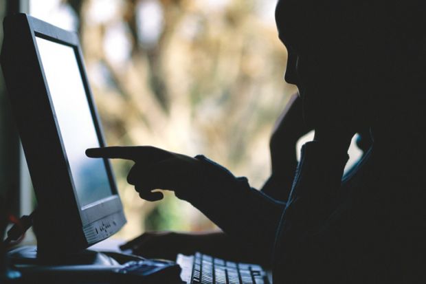 Silhouette of people using desktop PC