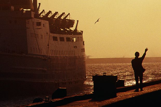 Silhouette of person waving to departing ferry, Boulogne-sur-Mer, France