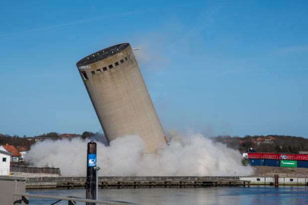 A falling silo, illustrating moving beyond siloed education tracks