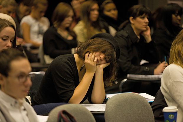 Woman sleeping in lecture theatre