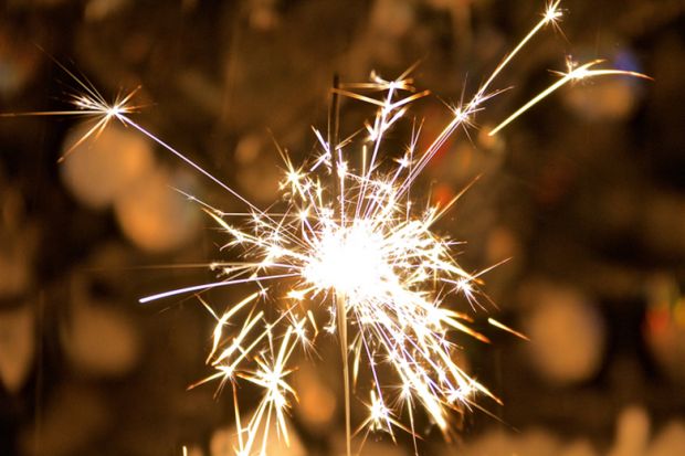 A sparkler held in someone’s hand