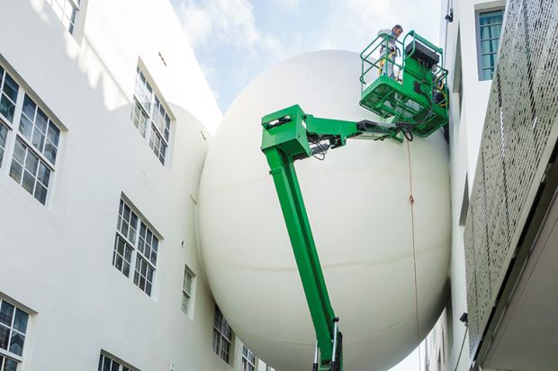 Giant balloon wedged between two buildings