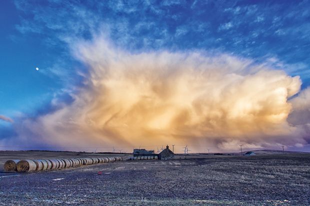 Storm gathering over farmland