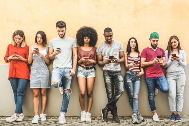 A group of students using mobile phones, symbolising student technology councils 