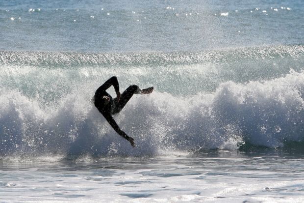 Surfer wiping out on wave, Mojácar, spain