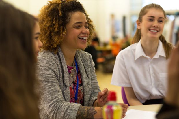 Female teacher with female pupil in a classroom