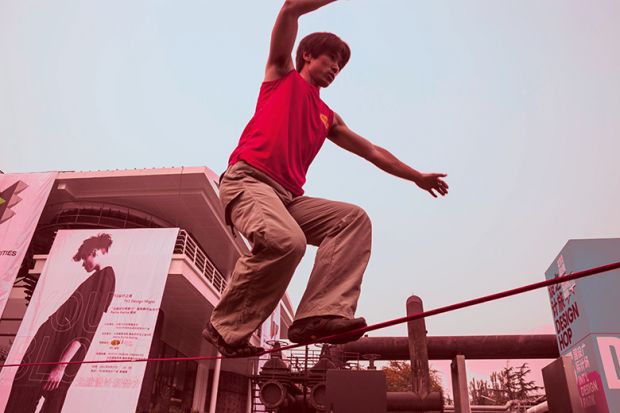 man walking on tightrope