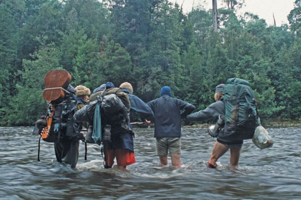 Trekkers crossing river, Tarkine rainforest