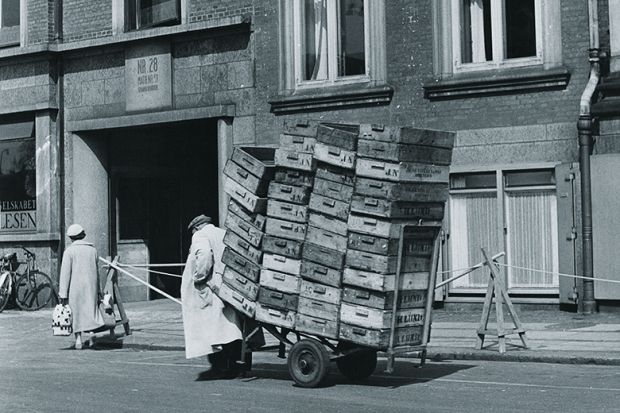 man pulls a heavy trolley