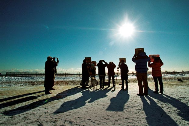 Group of people watching eclipse in Canada