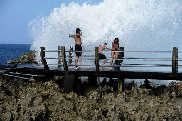 People splashed with big wave