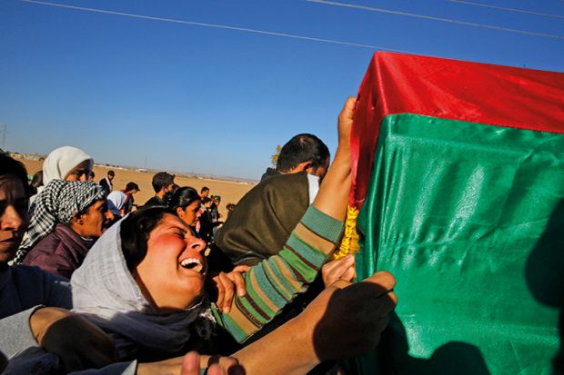 Woman grieving at funeral with coffin